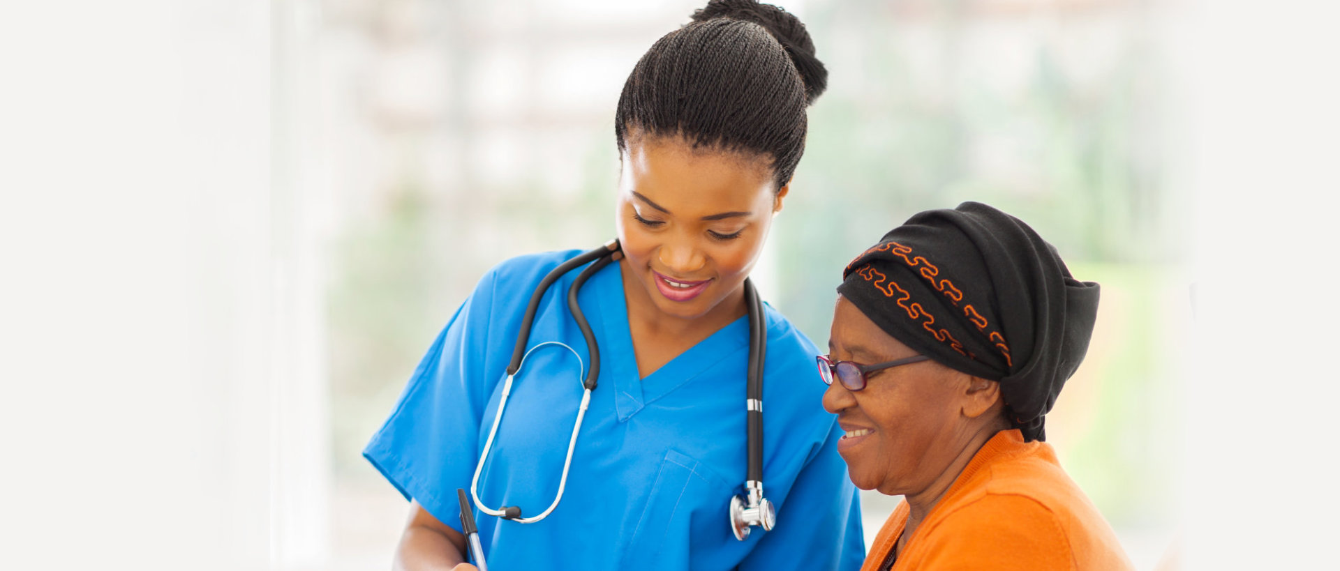 nurse and senior woman having discussion